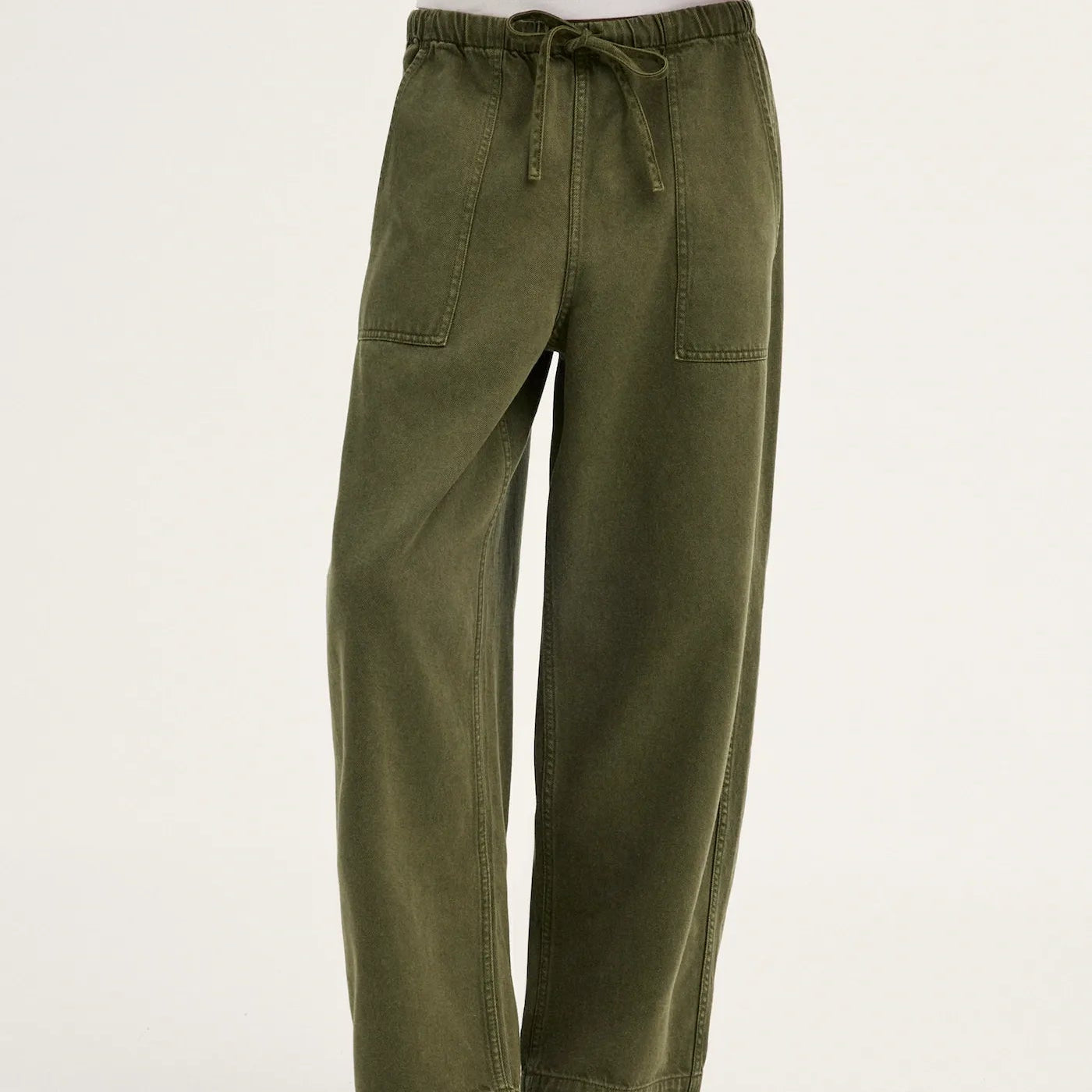 Olive green wide-leg pants with an elastic drawstring waist and side pockets, shown on a model wearing black flip-flop sandals against a plain white studio background.